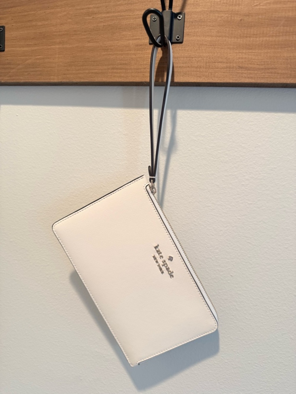 kate spade cream wristlet clutch with black strap